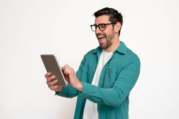 istock Cheerful man laughing with tablet 2153546878
