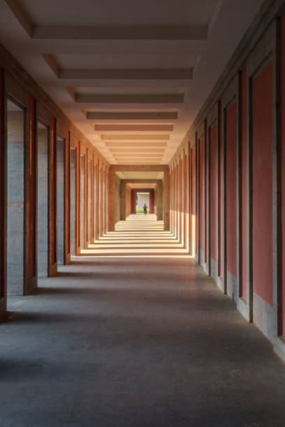istock The hallway is long with red walls and columns, creating a bold aesthetic 2153549967