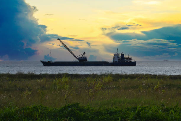 The scenery image of the vessel silhouette under the sunset sky