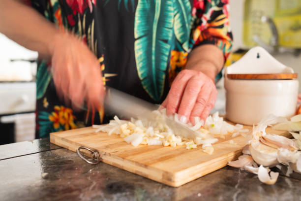 istock unrecognizable woman slicing garlic on cutting board.motion blur image. 2153551009