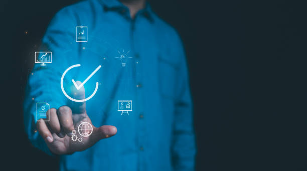 istock Businessman with guarantee check for client service. Client service and guarantee checkmark in business automation, quality management, online shopping, business automation, and financial ecosystem. 2153553426