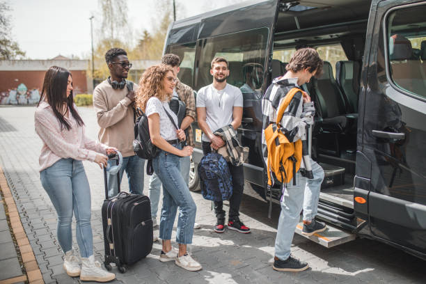 istock A young man with a yellow backpack on his back gets into the minibus 2153559050