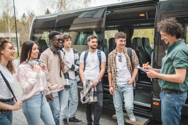 istock Smiling professor calls the students before entering the bus, they are ready for a joint journey and adventure 2153560426