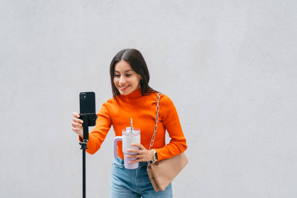Content creator filming video on a smartphone outdoors