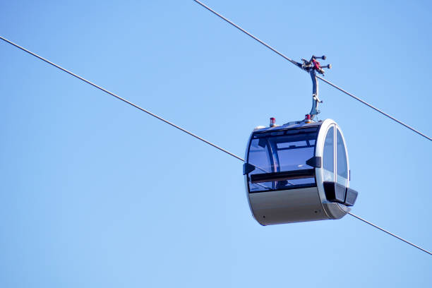 Empty cable car cabin against the sky. Modern glass lift cabin.