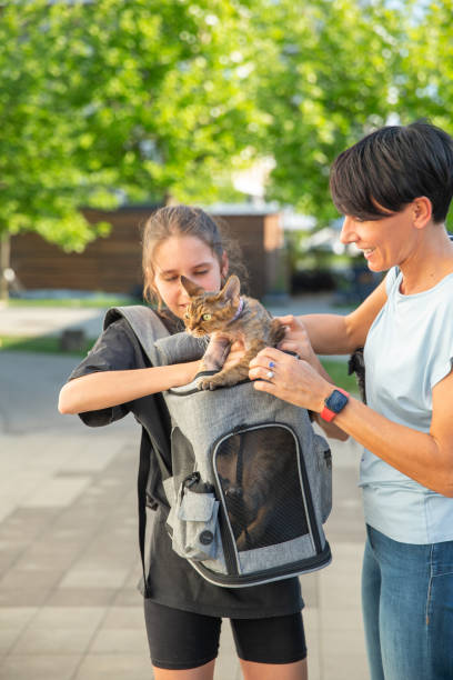 istock Mother and daughter and her pet in a cat backpack 2153576442