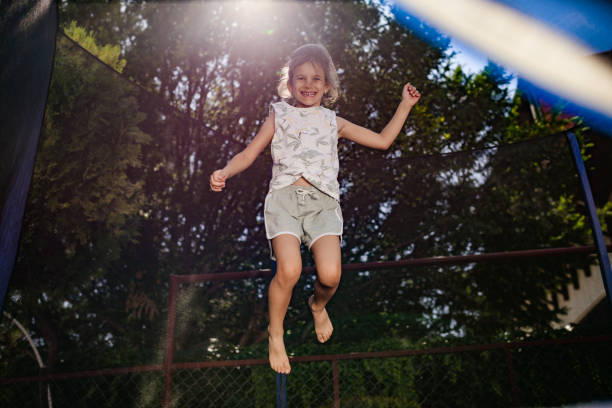 Blonde hair billows around a young girl's poised figure, symbolizing freedom and spontaneity