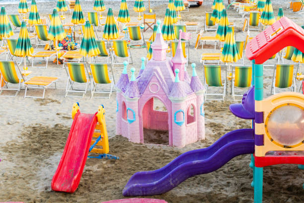 istock playground and beach umbrellas on sandy shore 2153594392