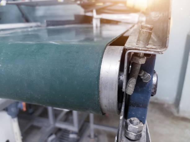 Close up the conveyor belt on the machinery.