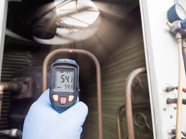Checking and measuring  temperature using a thermo gun in the refrigeration system in HVAC air conditioning. Refrigeration check using thermo gun with concept professional hvac service.