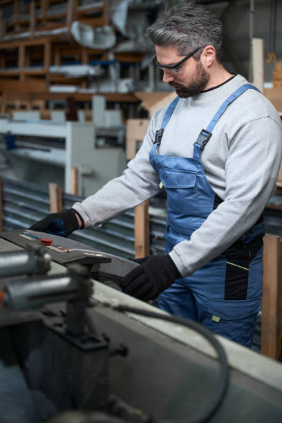 istock Middle-aged man works in a production workshop on modern machine 2153595814
