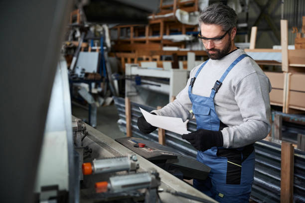 istock Specialist with working documentation at the workplace in the workshop 2153595822