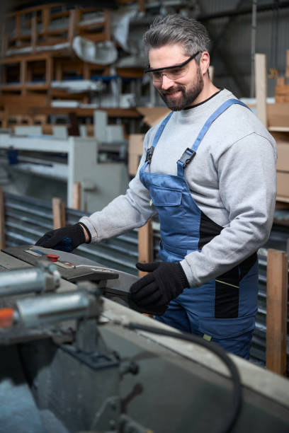 istock Middle-aged specialist works in a production workshop on modern machine 2153595836