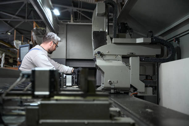 istock Man works on modern equipment in a production workshop 2153595856