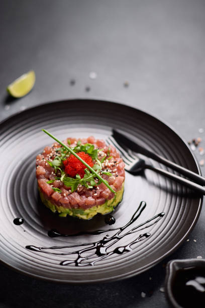 istock Tuna and avocado tartare on a dark ceramic plate 2153597737