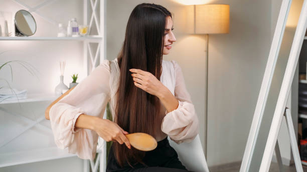 istock Strands brushing woman combing long hair home 2153597767