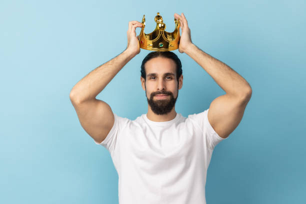istock Man wearing golden crown, looking with arrogance and confidence, privileged status. 2153598262