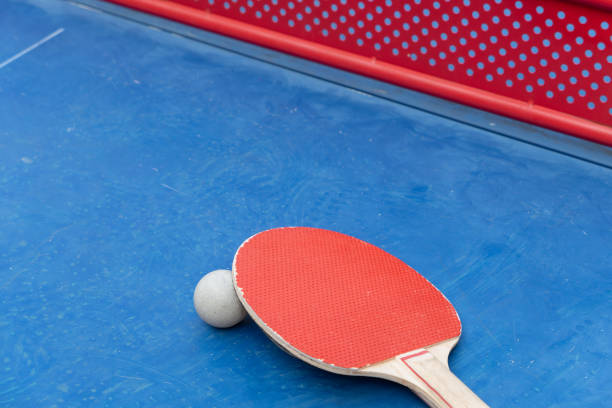 istock angle view pingpong racket and ball and net on a blue pingpong table at horizontal composition 2153599320
