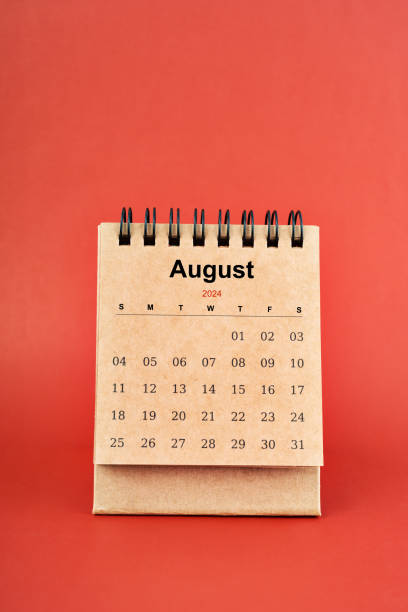 istock August 2024 white mini desk calendar on red background. 2153608498