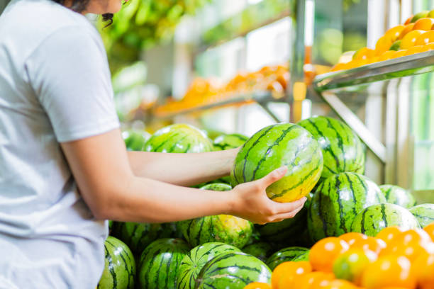 istock young woman's hand choosing watermelon 2153608678