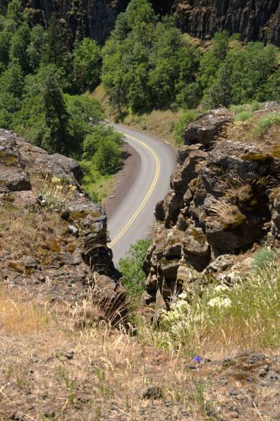 istock View down to a road winding through a dramatic landscape 2153613727