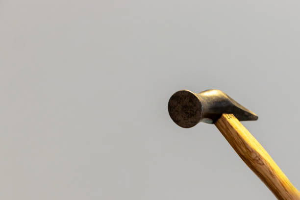 Close-Up Of Hammer Over Blue Background