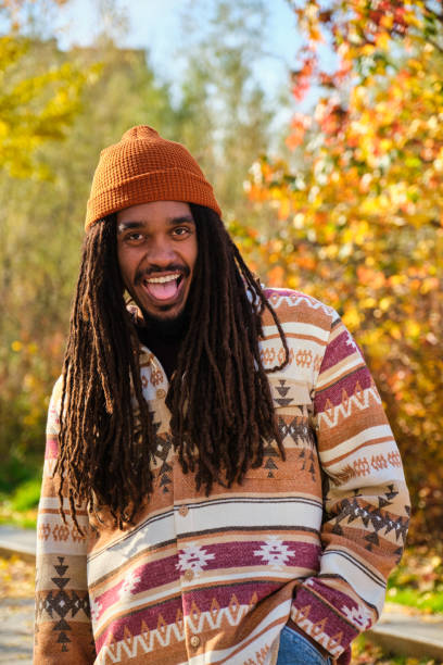 istock African young man with dreadlocks laughing and looking at camera in fall. 2153619633