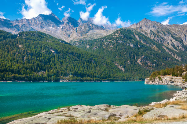 istock Alpine lake and mountains under blue sky in Italy. 2153622664