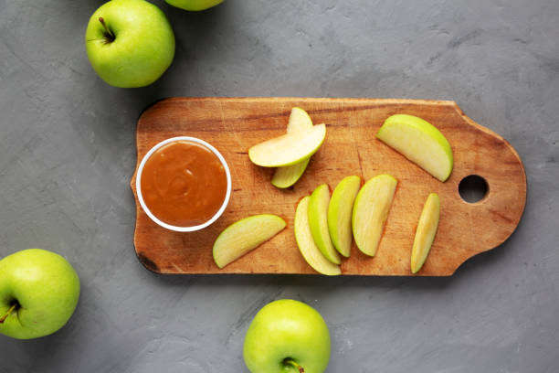 istock Homemade Caramel Apple Dip on a rustic wooden board, top view. Flat lay, overhead, from above. 2153627608