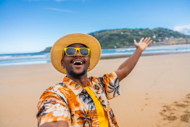 istock African man taking a selfie enjoying holidays on the beach 2153627797