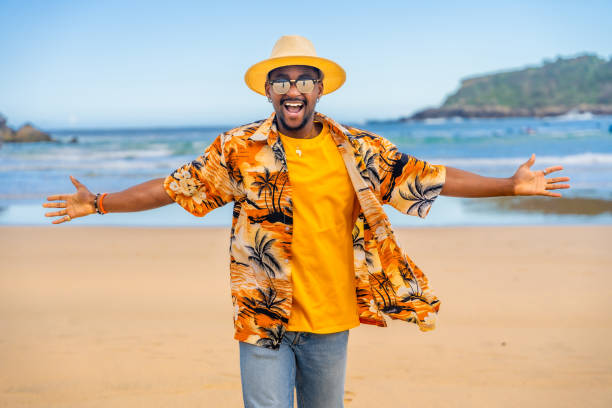 istock Afro cool man in colorful clothes embracing holidays at beach 2153627887