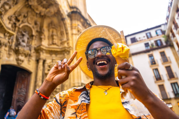 istock Tourist gesturing victory while eating ice cream outdoors 2153627999