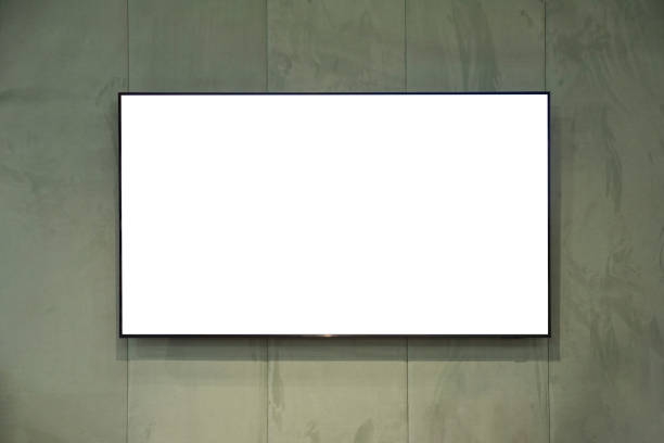 Blank screen TV mounted on green fabric wall