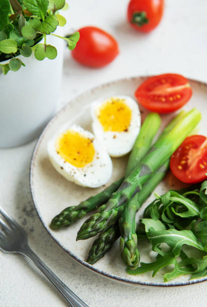 istock Fresh Spring Salad With Boiled Eggs, Asparagus, and Tomatoes on a Bright Day 2153632198