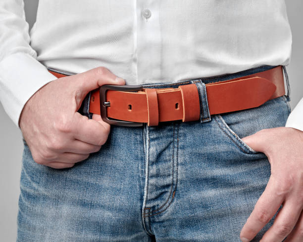 istock Cropped view of man wearing custom embossed leather belt 2153634312