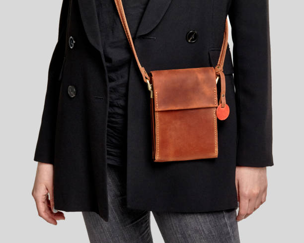 istock Brown leather crossbody messenger bag complementing stylish feminine look 2153634324