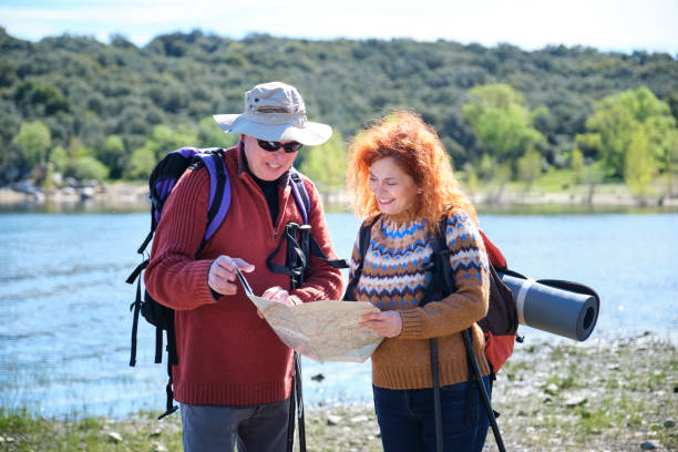 istock A man and woman are looking at a map while standing by a lake 2153636251