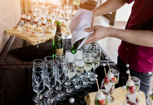 istock wine waiter pouring sparkling wine 2153636724