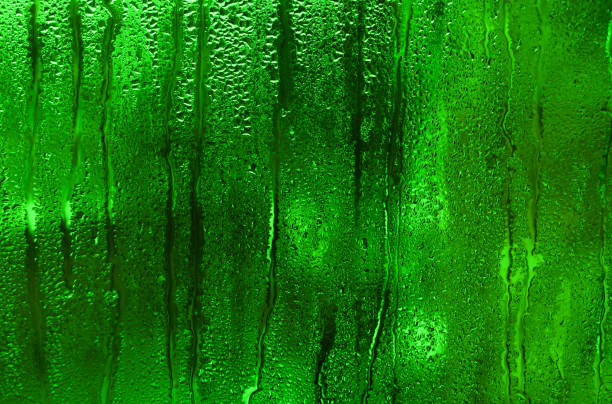 istock The defocus is an abstract textured green background. wet glass 2153638676