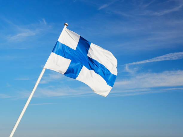 istock Finnish flag on the flagpole against the blue sky. 2153640308