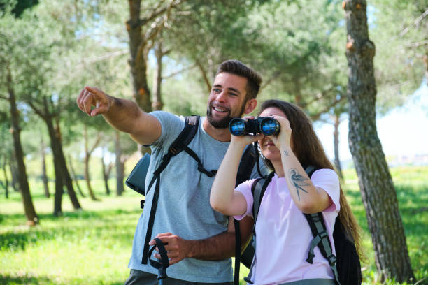 istock A man and a woman are looking through binoculars in a park 2153641863