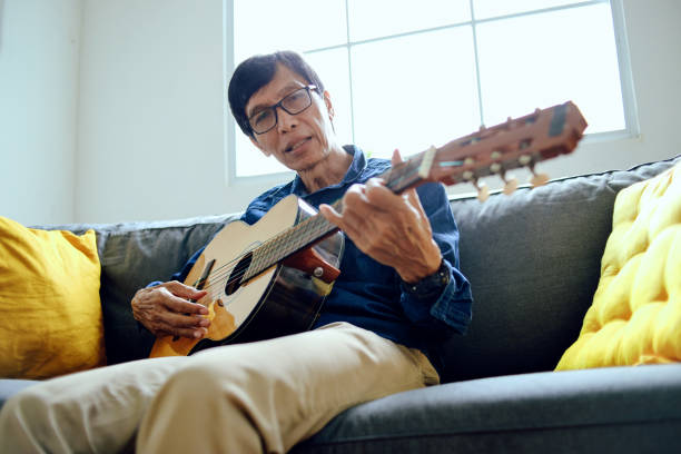 istock Senior Man Playing Music At Home 2153641873