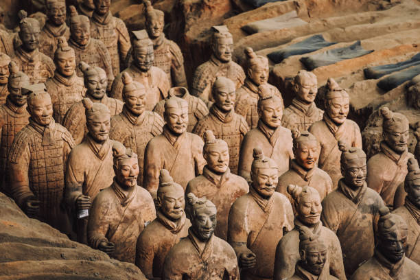 Terracotta Army Soldiers Standing in Ancient Burial Pit Xian, Shanxi, China - October 24, 2015: Close-up view of the Terracotta Army soldiers standing in an ancient burial pit, representing historical Chinese warriors. terracotta soldiers stock pictures, royalty-free photos & images