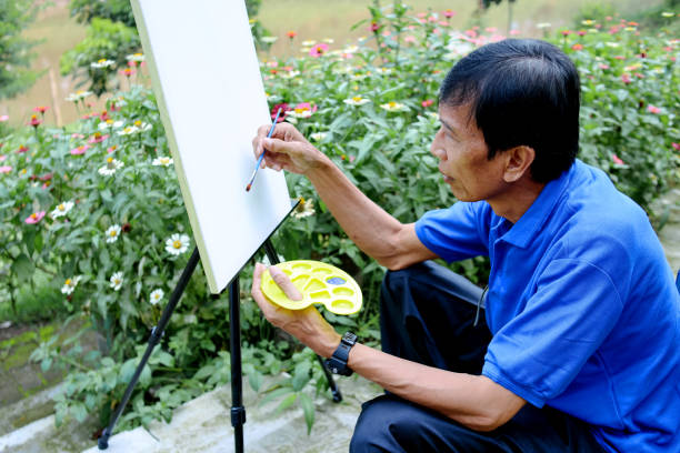 Senior Man Start To Painting With Brush Outdoor