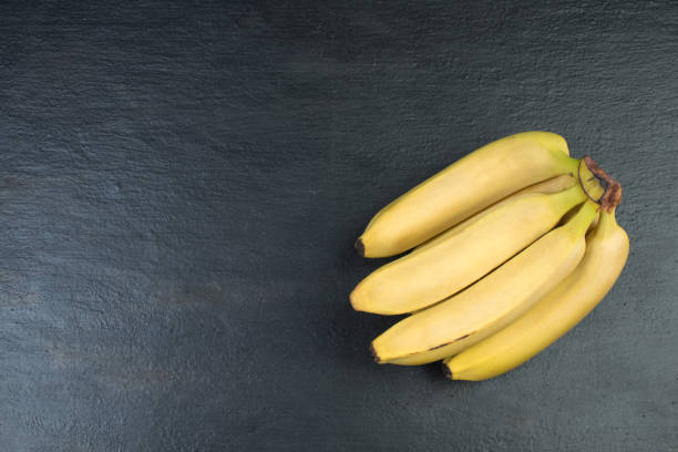 istock Bunch of bananas on a black background. Top view. 2153642321
