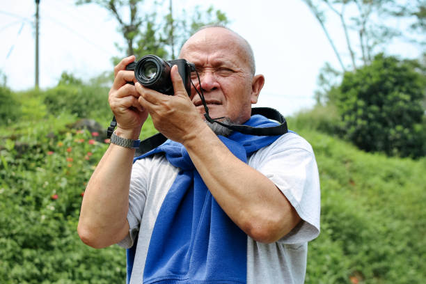 Focused Senior Man Taking Photograph of Nature Outdoor