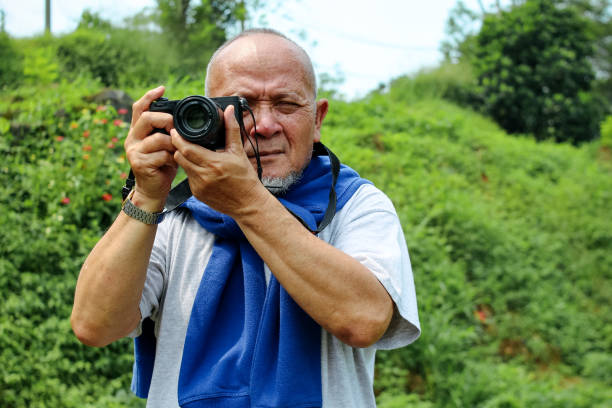 Close up Of Senior Man With Camera Lens Shoot Nature View