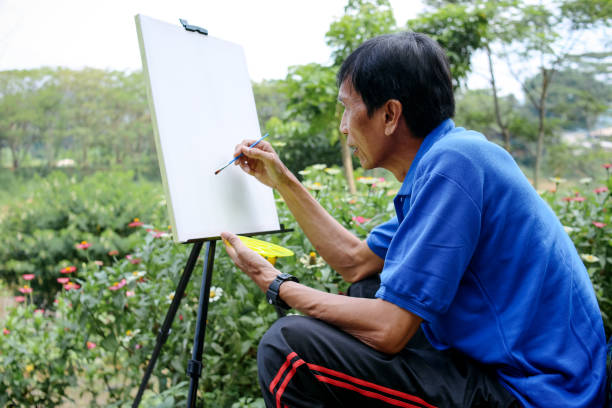 Senior Man Start Painting on Canvas With Palette Outside The House