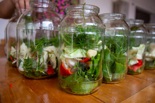 istock A table with several jars of food, including pickles and vegetables 2153643219
