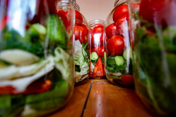 istock A row of jars filled with vegetables including cucumbers, tomatoes, and peppers 2153644096